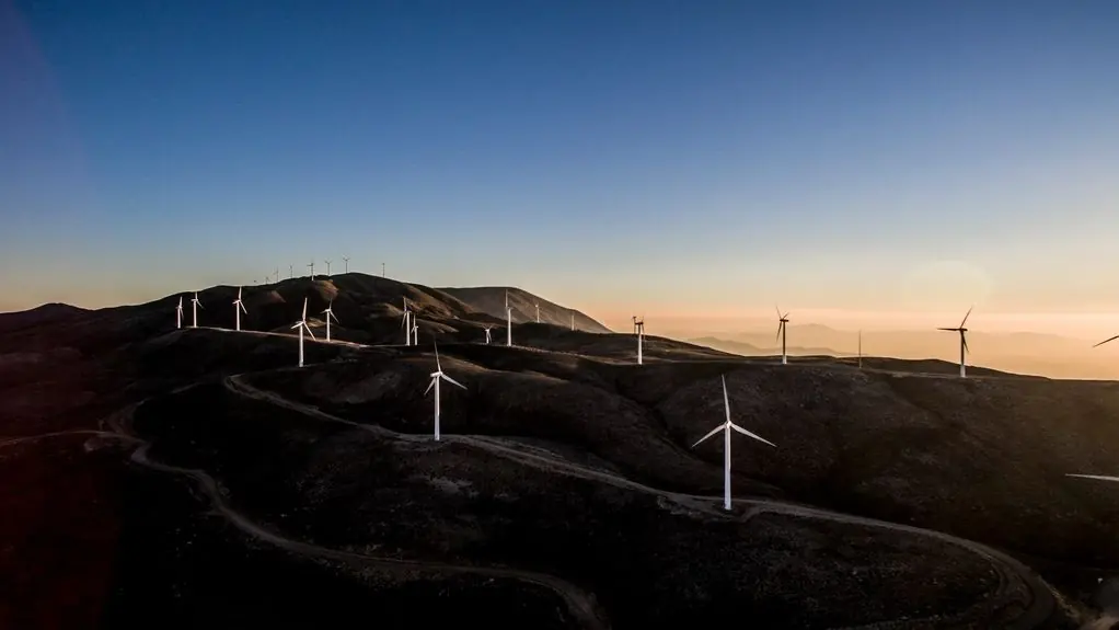 Wind turbines on hills at dusk
