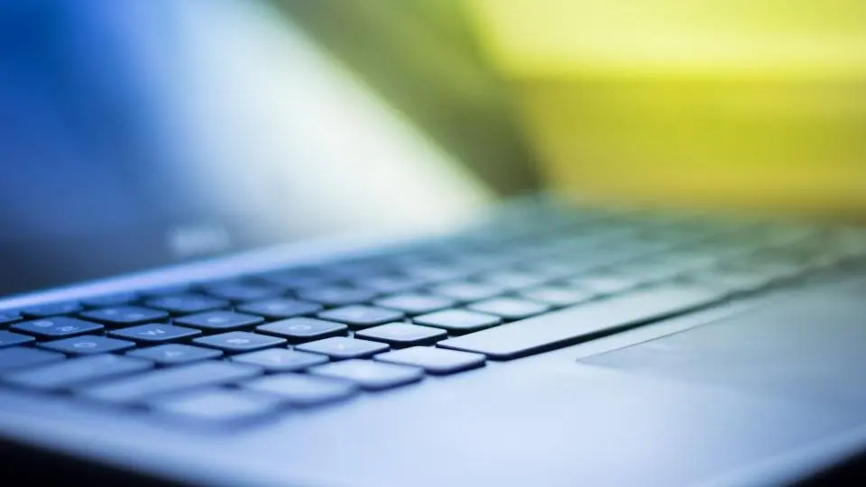A laptop keyboard in blue light