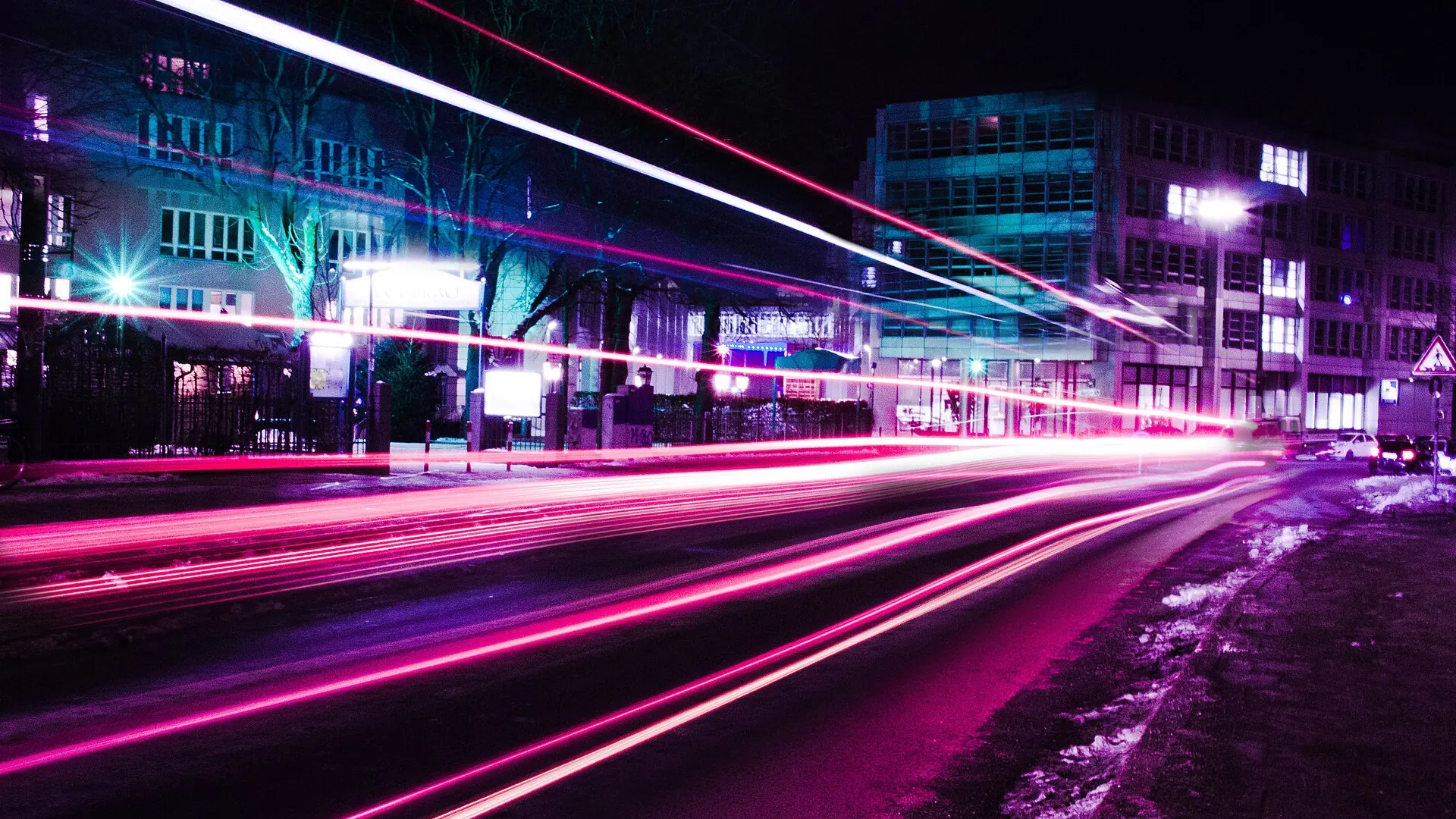 Trails of car lights through a city at night