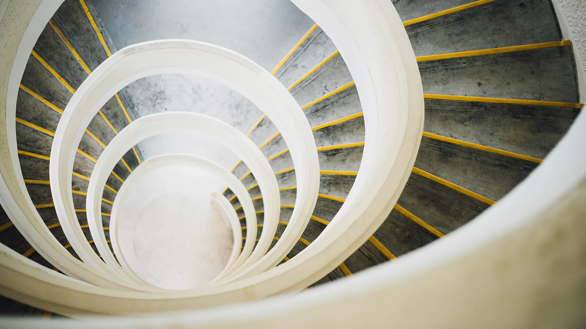 A white and yellow spiral staircase from above