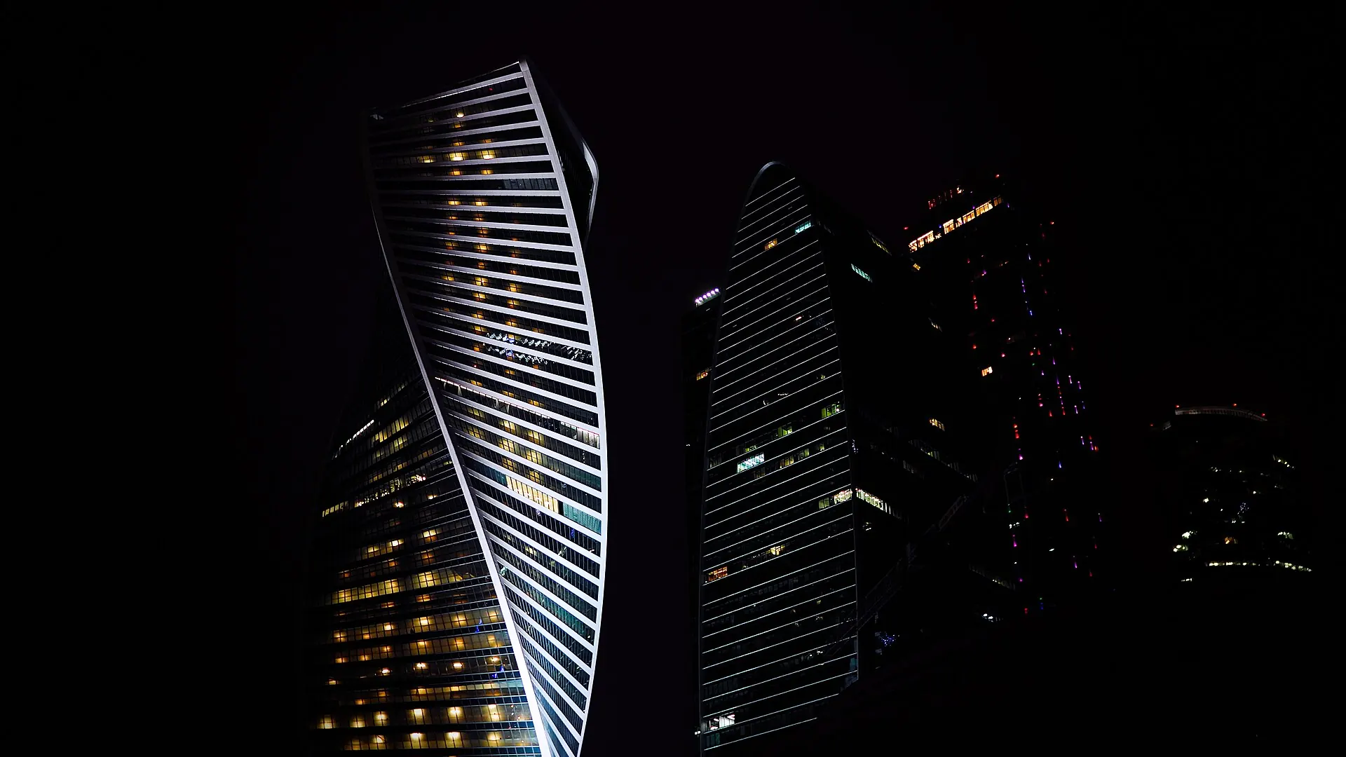 A twisting tower lit at night